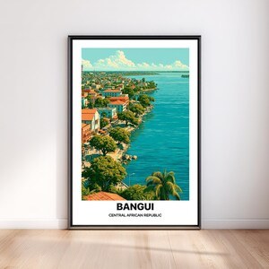May include: A framed vertical travel poster featuring a vibrant illustration of the Bangui riverfront in the Central African Republic, with lush green trees, orange-roofed buildings, and deep blue water under a bright sky with the text BANGUI CENTRAL AFRICAN REPUBLIC.