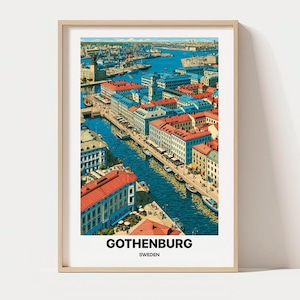 May include: A framed art print featuring a high-angle illustration of Gothenburg, Sweden, with a canal flowing through city buildings with red roofs and blue facades. The text GOTHENBURG SWEDEN is printed in black at the bottom of the white border.