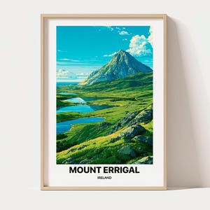 以下が含まれることがあります： アイルランドのエリガル山の風景イラストが描かれた額装アートプリント。緑の丘、青い湖、白い雲が浮かぶ明るい青空の上に、大きな尖った山の頂がそびえ立つ様子が描かれています。テキストには「MOUNT ERRIGAL IRELAND」と記されています。