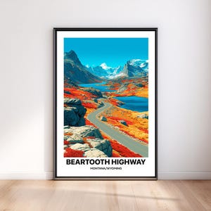 May include: A vertical framed art print featuring a landscape illustration of the Beartooth Highway in Montana and Wyoming. The image displays a winding road through mountains, blue lakes, and vibrant red and orange foliage under a clear blue sky.