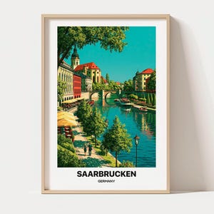 May include: A framed travel poster featuring a vibrant illustration of Saarbrücken, Germany, with a river, stone bridge, historic buildings, green trees, and people walking along the bank. The text at the bottom reads SAARBRUCKEN GERMANY.
