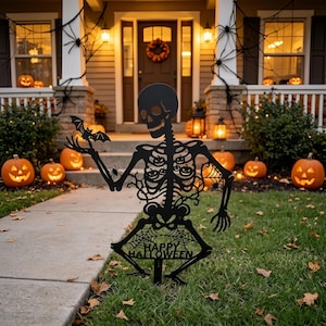 May include: A black metal skeleton yard sign featuring a bat perched on one hand, spider web details, and small pumpkin cutouts within the ribcage. The base of the skeleton includes the text HAPPY HALLOWEEN integrated into a spider web design.