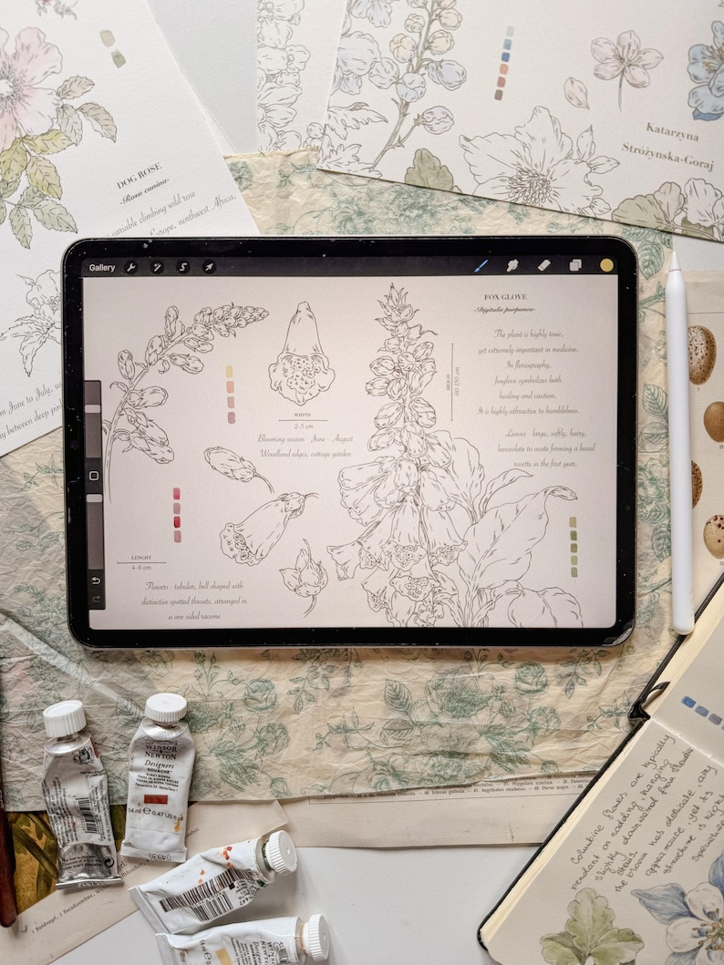 May include: A digital tablet displaying a botanical illustration of a foxglove plant with line drawings, text, and color swatches. The screen shows the text FOX GLOVE, Digitalis purpurea, and descriptive notes. A white stylus rests beside the tablet.