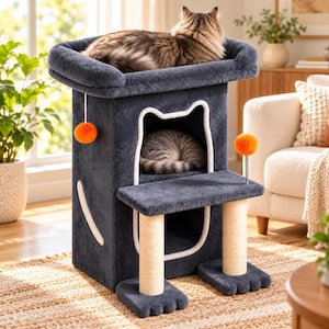 May include: A dark gray cat tree with a plush top perch, a cat-shaped entrance leading to an interior cubby, two sisal-wrapped scratching posts, and two orange ball toys. The structure features a soft, fuzzy texture and white trim accents.
