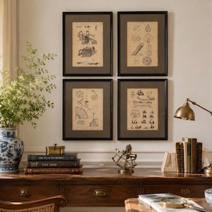 May include: Four framed vintage-style technical drawings of nautical equipment and ships displayed in a grid on a wall. The prints feature black ink illustrations on aged paper, each enclosed in a dark brown mat and a simple black frame.