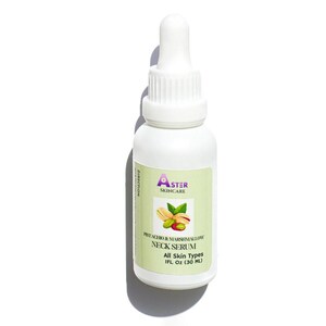May include: White bottle of Aster Skincare Pistachio & Marshmallow Neck Serum. The label features a pistachio and leaf graphic. The bottle has a dropper top and contains 1 fl oz (30 ml) of serum. The label states "All Skin Types."