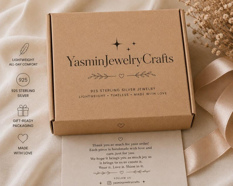 May include: A rectangular brown cardboard jewelry box with the text YasminJewelryCrafts printed in black on the lid. The box features decorative star and heart icons. Below the box is a thank you note with printed text and social media details.