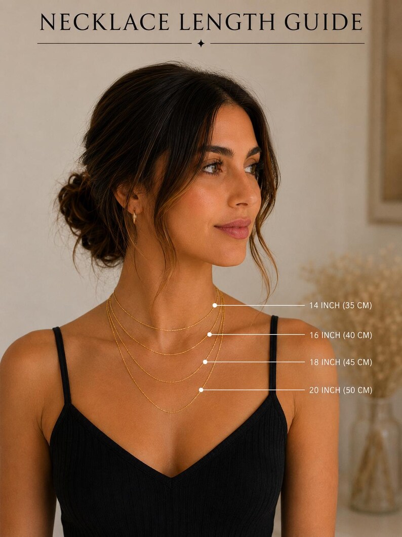 May include: A necklace length guide featuring four gold chains of varying lengths. Text labels indicate 14 inches (35 cm), 16 inches (40 cm), 18 inches (45 cm), and 20 inches (50 cm). The graphic displays the chains layered on a neck.