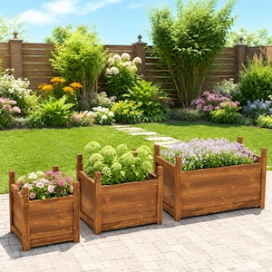 May include: A set of three rectangular wooden planters with a dark brown finish and decorative corner posts. The planters are arranged in a row on a stone patio, each containing green foliage and small pink, white, and purple flowering plants.