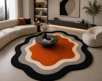Verbrand oranje vloerkleed, zwart crèmekleurig design tapijt, organisch abstract handgetuft, grijs golvend sculpturaal stuk, luxe woonkamer, slaapkamer