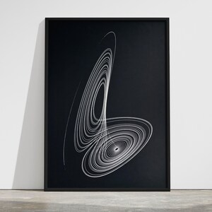 May include: A framed vertical wall art print featuring a white line drawing of a Lorenz attractor on a solid black background. The graphic consists of complex, swirling, concentric elliptical loops that create a dynamic, abstract geometric pattern.