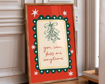 May include: A rectangular framed print with a red background featuring white stars and a central cream-colored rectangle with a dark green scalloped border. The center displays a green mistletoe illustration and the text you can kiss me anytime.