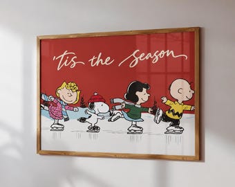 May include: A framed horizontal wall art print featuring a red background with the white cursive text 'Tis the season'. The illustration depicts Sally, Snoopy, Lucy, and Charlie Brown ice skating on a white surface with black outlines.