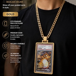 May include: A gold-coloured slab chain necklace holder designed to display a graded trading card. The holder features a thick, metallic-finish chain connected to a rectangular frame that securely encases a PSA-graded Pokemon card.