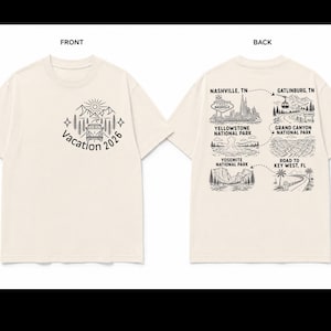 May include: A cream-colored t-shirt featuring a black line-art graphic. The front shows a van, mountains, and the text 'Vacation 2026'. The back displays a travel map with illustrations of Nashville, Gatlinburg, Yellowstone, Grand Canyon, Yosemite, and Key West.