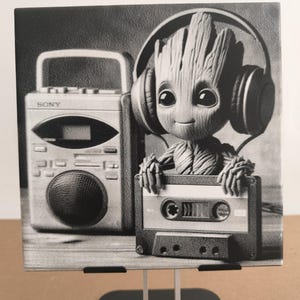 May include: A square black and white print featuring a tree-like character wearing headphones, holding a cassette tape, and positioned next to a Sony boombox. The image displays a detailed illustration of the character and audio equipment.