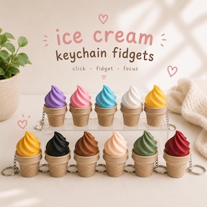 May include: Eleven ice cream cone keychains in various colors including purple, pink, blue, white, yellow, black, brown, peach, green, and red. The text reads ice cream keychain fidgets, click, fidget, focus with small heart illustrations.