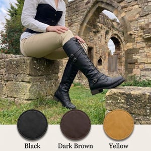 May include: Black knee-high boots featuring a lace-up front, side buckles, and a low heel. Below the boots are three circular color swatches labeled Black, Dark Brown, and Yellow, representing the available color options for this footwear.