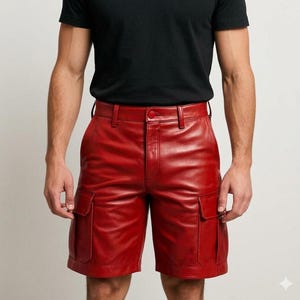 May include: Red leather cargo shorts with two front pockets and a button closure. The shorts have belt loops and a classic design. The shorts are made of a shiny, smooth leather material.