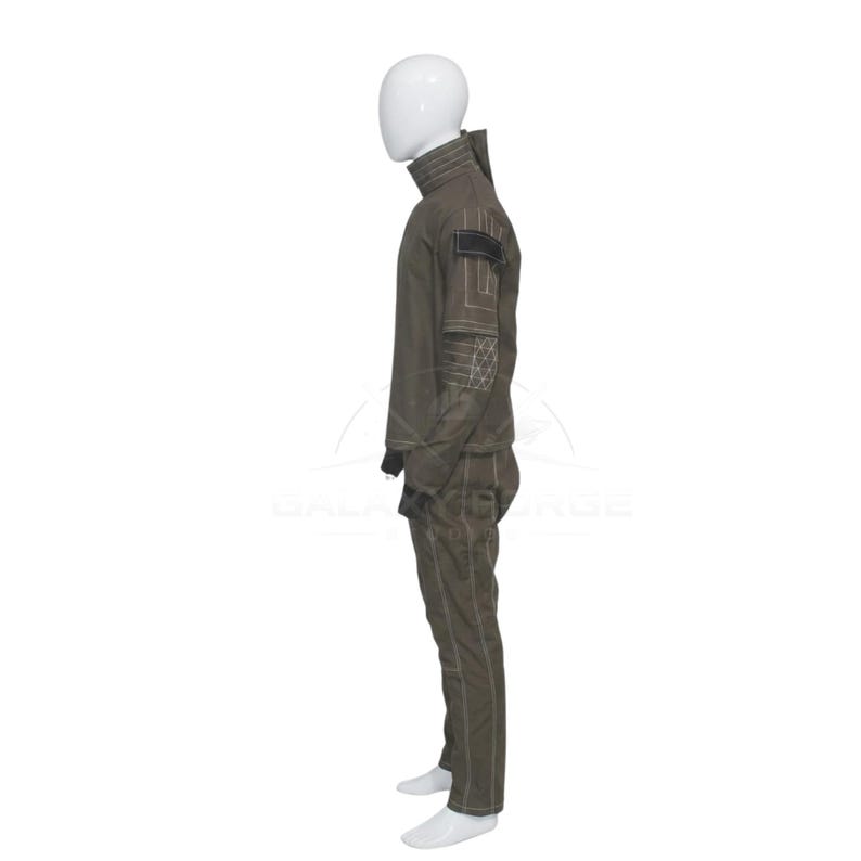 May include: A dark olive green long-sleeved jacket and matching trousers set displayed on a white mannequin. The jacket features a high collar, a black rectangular patch on the upper arm, and white contrast stitching with geometric patterns.