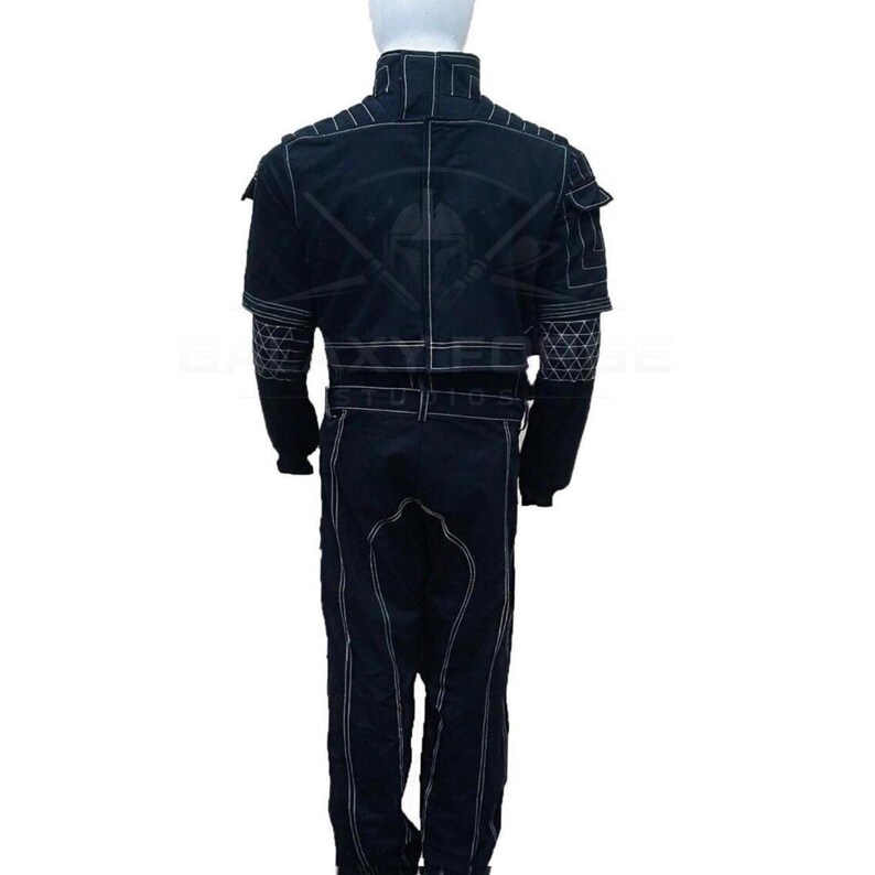 May include: Black jumpsuit with white stitching details. The suit features a high collar, multiple pockets, and a belt. The back of the suit has a graphic design. The jumpsuit is made of a durable material.
