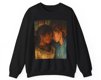 May include: Black sweatshirt with a printed image of two women in a close embrace. The artwork shows the women with their faces close together, one in a white top and the other in a blue top. The image has a painterly style.