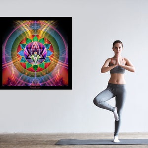 May include: A woman in grey yoga pants and a grey sports bra stands on a yoga mat in a tree pose. Behind her is a framed print of a colorful mandala with the text "Ring of Love".