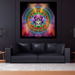 May include: A black leather couch with a colorful geometric mandala print hanging on the wall behind it. The mandala is surrounded by a ring of light and has a star in the center. Two black geometric pendant lights hang from the ceiling.