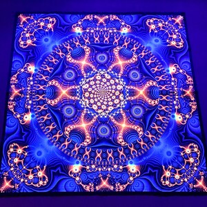 May include: A psychedelic tapestry with a blue background and a large, intricate, orange and white mandala design.