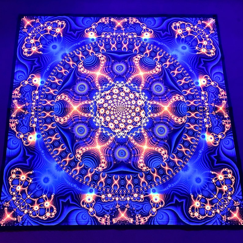 May include: A psychedelic tapestry with a blue background and a large, intricate, orange and white mandala design.