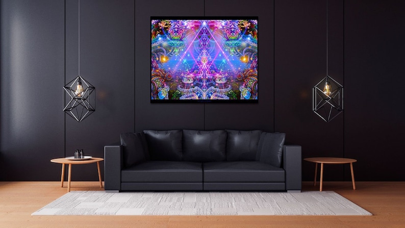 May include: A black leather sofa with a colorful abstract painting hanging above it. The painting features a geometric design with pink, blue, and purple hues. Two black geometric pendant lights hang from the ceiling on either side of the painting.