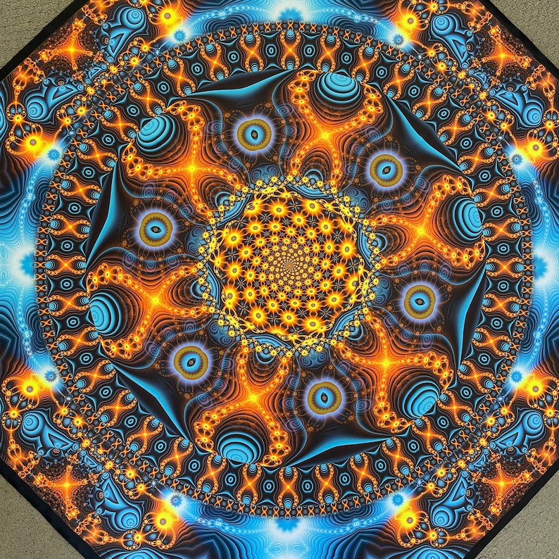 May include: A psychedelic mandala with a swirling pattern of blue, orange, and yellow. The center of the mandala is a spiral of yellow and orange.