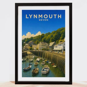 Puede incluir: Un póster de viaje enmarcado que muestra una escena costera de Lynmouth, Devon, con pequeños barcos amarrados en un puerto, un muro de piedra y edificios junto a una colina verde bajo un cielo azul con el texto LYNMOUTH DEVON arriba.