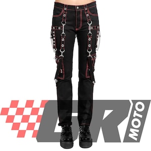 May include: Black pants with red stitching and accents. The pants feature multiple straps, metal rings, and chains. The design includes red stitching along the seams and pockets. The pants are worn with black platform shoes.