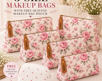 May include: A set of five makeup bags featuring a pink floral pattern on a cream background, each with a brown leather-like zipper pull. The set includes four rectangular bags and one smaller white quilted pouch with a red heart pattern.