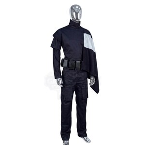 May include: A dark navy blue costume set featuring a high-neck long-sleeve top with a white shoulder panel, a matching dark navy blue utility belt with multiple rectangular pouches, and dark navy blue cargo-style trousers on a silver mannequin.