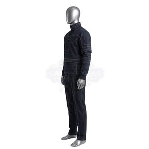 May include: A dark navy blue long-sleeve mock neck shirt and matching trousers set featuring prominent white contrast stitching. The garment displays geometric paneling and linear patterns across the chest, sleeves, and legs, worn on a silver mannequin.