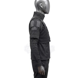 May include: A black costume featuring a high collar, shoulder patches, and a geometric pattern on the sleeves. The outfit includes a vest-like top and long sleeves, with a tailored fit. The costume is displayed on a mannequin.