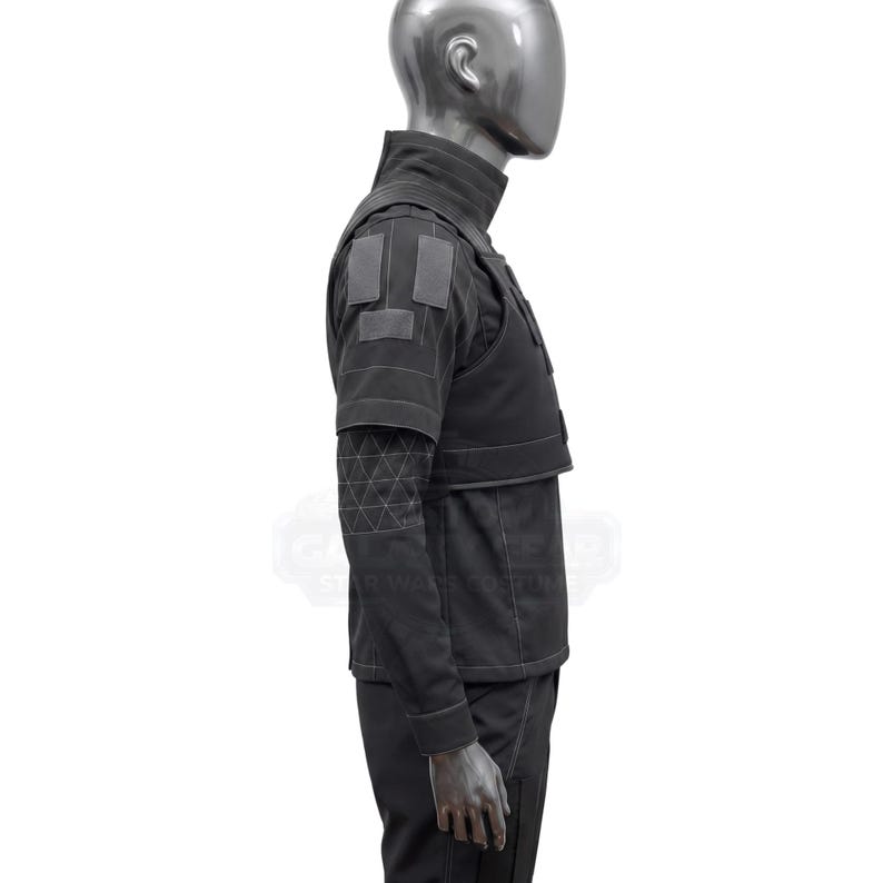 May include: A black costume featuring a high collar, shoulder patches, and a geometric pattern on the sleeves. The outfit includes a vest-like top and long sleeves, with a tailored fit. The costume is displayed on a mannequin.