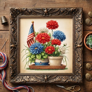 May include: Cross-stitch art of red, white, and blue flowers and an American flag in a decorative frame. The frame has eagle and star details. Additional craft supplies include thread, scissors, and a thimble.