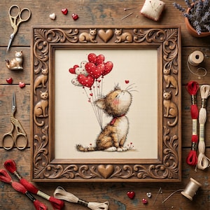 May include: A framed cross-stitch of a cat holding heart-shaped balloons. The brown wooden frame has carved cat and heart details. Red and white heart-shaped embellishments and embroidery floss surround the frame. Gold scissors and a ceramic cat figurine are also present.