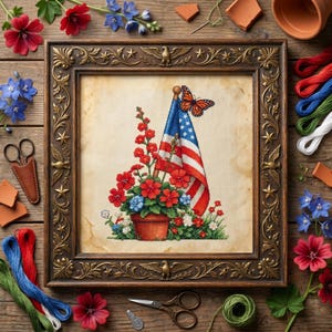 May include: A framed cross-stitch depicting an American flag, flowers, and a butterfly. The artwork features red, white, and blue colors, with a detailed floral arrangement in a terracotta pot. The frame is ornate with decorative elements.