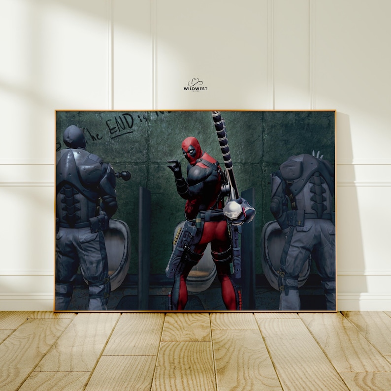 May include: A framed print featuring a comic book scene with Deadpool in a red and black suit, holding a weapon, and two figures in gray armor. The words "The END is near" are written on the wall. The image is set in a bathroom.