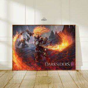 May include: A framed Darksiders III art print. The artwork depicts a fiery female warrior with flaming hair and weapons, set against a backdrop of fire and a rocky landscape. The Darksiders III logo is visible.