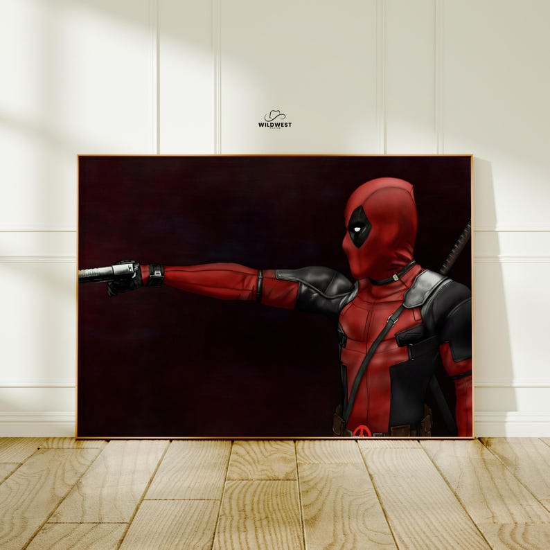 May include: A framed artwork featuring the character Deadpool in a red and black costume, holding a gun. The artwork has a dark background and is set in a gold frame. The character is in a shooting pose.