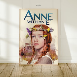 May include: A framed poster featuring the title "Anne with an 'E'" in blue letters. The image shows a young woman with red braids and a floral crown. A house and figures are in the background. The Wildwest logo is in the top right corner.