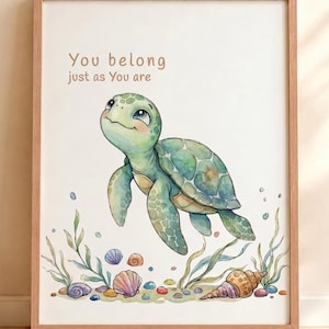 May include: A framed wall art print featuring a watercolor illustration of a green sea turtle swimming above colorful seashells and pebbles. The text "You belong just as You are" is printed in brown above the turtle on a white background.