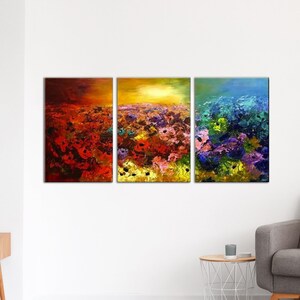 May include: A three-piece abstract painting set featuring a field of colorful flowers with a sunset in the background. The paintings are framed in wood and have a textured, brushstroke effect.