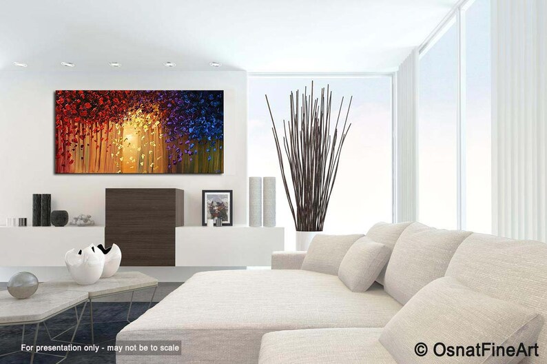 May include: Abstract painting with a colorful, textured, and layered design. The painting features shades of red, orange, yellow, blue, and green. The painting is displayed in a modern living room setting.