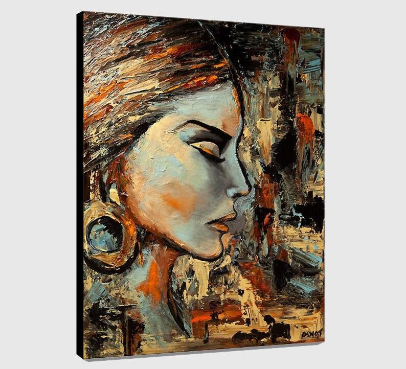 May include: Abstract painting of a woman's face with a large earring. The painting is done in a palette of blues, browns, and golds. The woman's face is in profile, and her eyes are closed. The background is a textured abstract design.